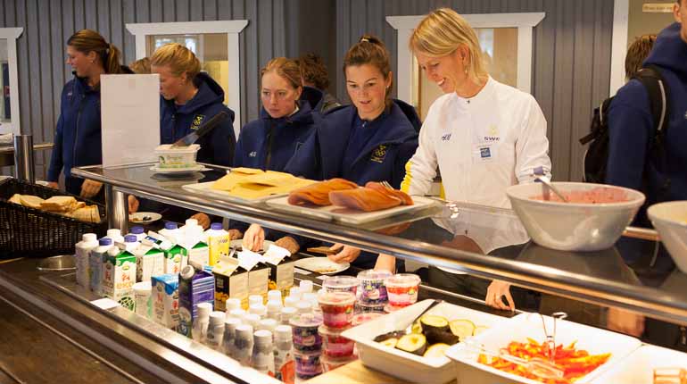 SOK:s kostrådgivare Linda Bakkman tillsammans med Utmanarna från ridsport, fälttävlan diskuterar vad de ska äta inför eftermiddagens fystester. Foto: SOK