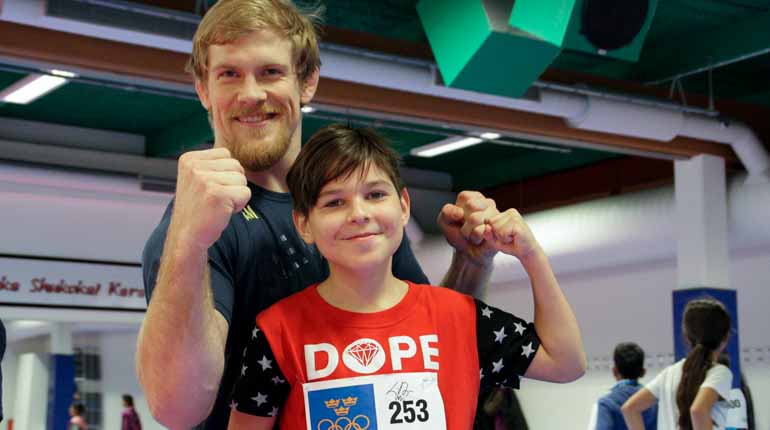 Judokan Joakim Dvärby tillsammans med en av deltagarna på Olympic Day i Botkyrka. Foto: SOK